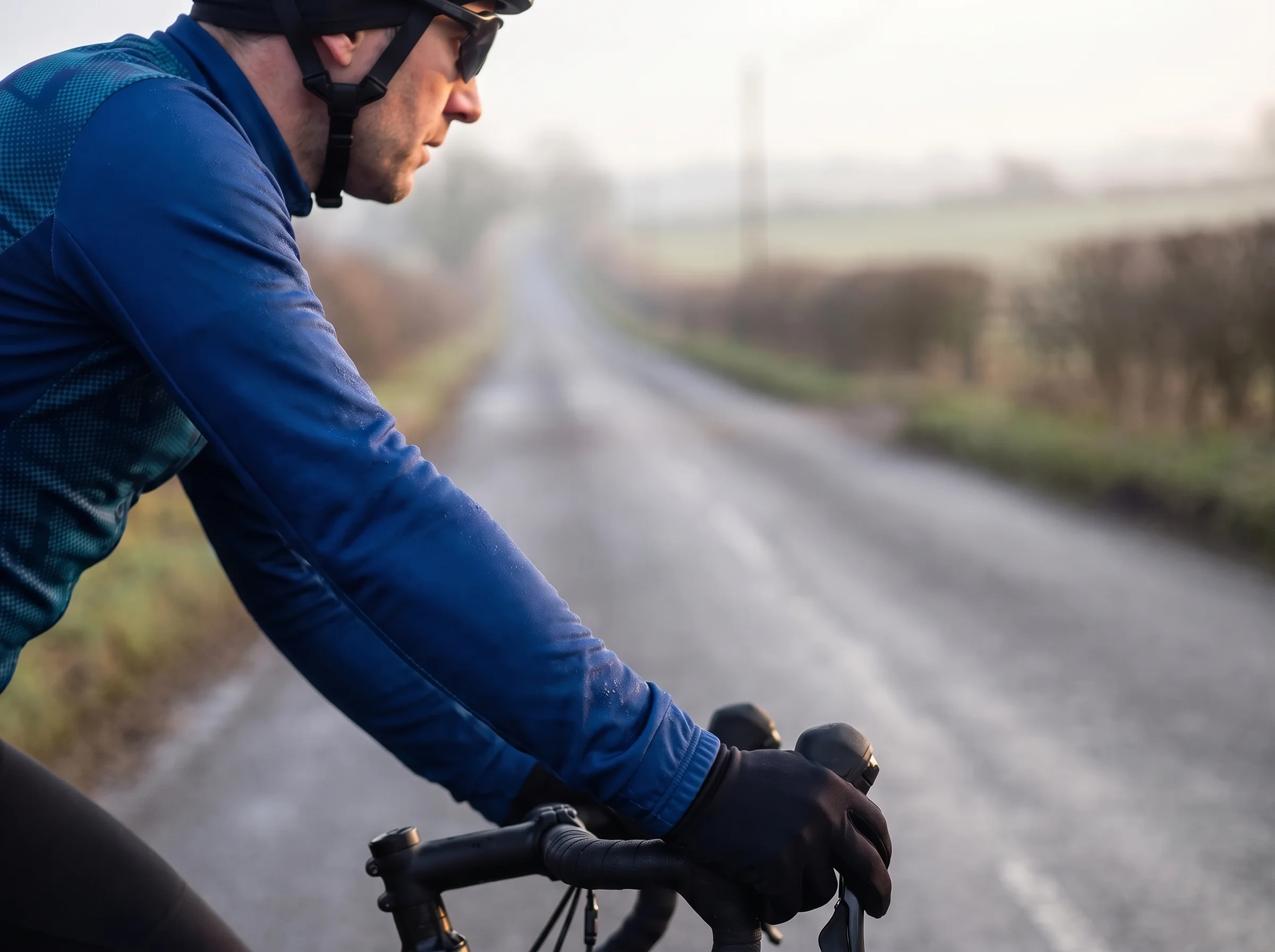 Long sleeve race fit jersey cuff covering the wrist with the rider's hands on the brake hoods